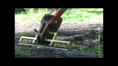 Homemade grading bar for mini excavator grapple attachment